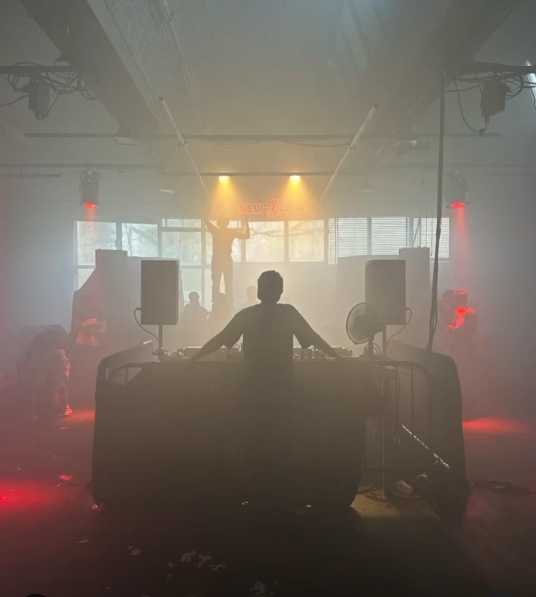 New Era Sessions booth, silhouette of a DJ under the neon New Era sign